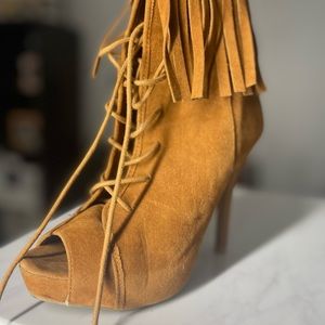 ankle cuff fringe stiletto high heel booties, a peep toe opening,
